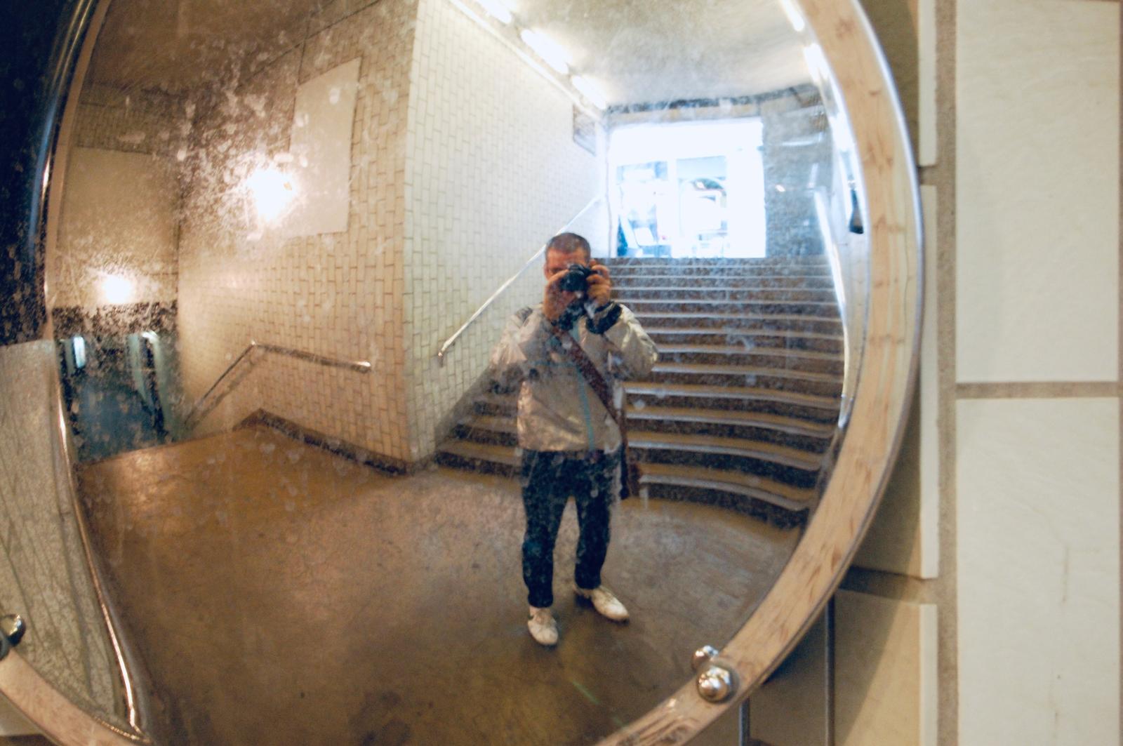 Me taking a mirror selfie in a tube station