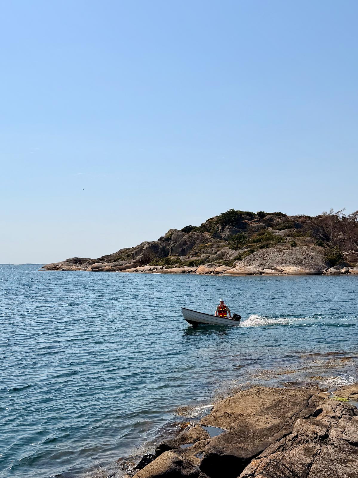 Me driving past in a small boat on a glorious Swedish summer day