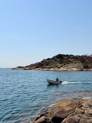 Me driving past in a small boat on a glorious Swedish summer day