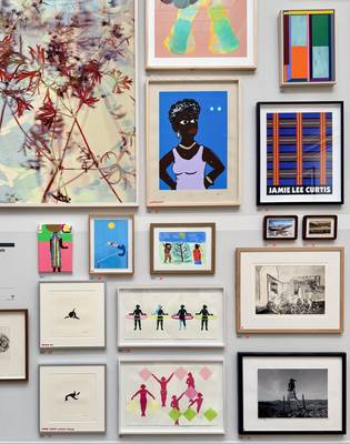 Multiple paintings closely together on a wall