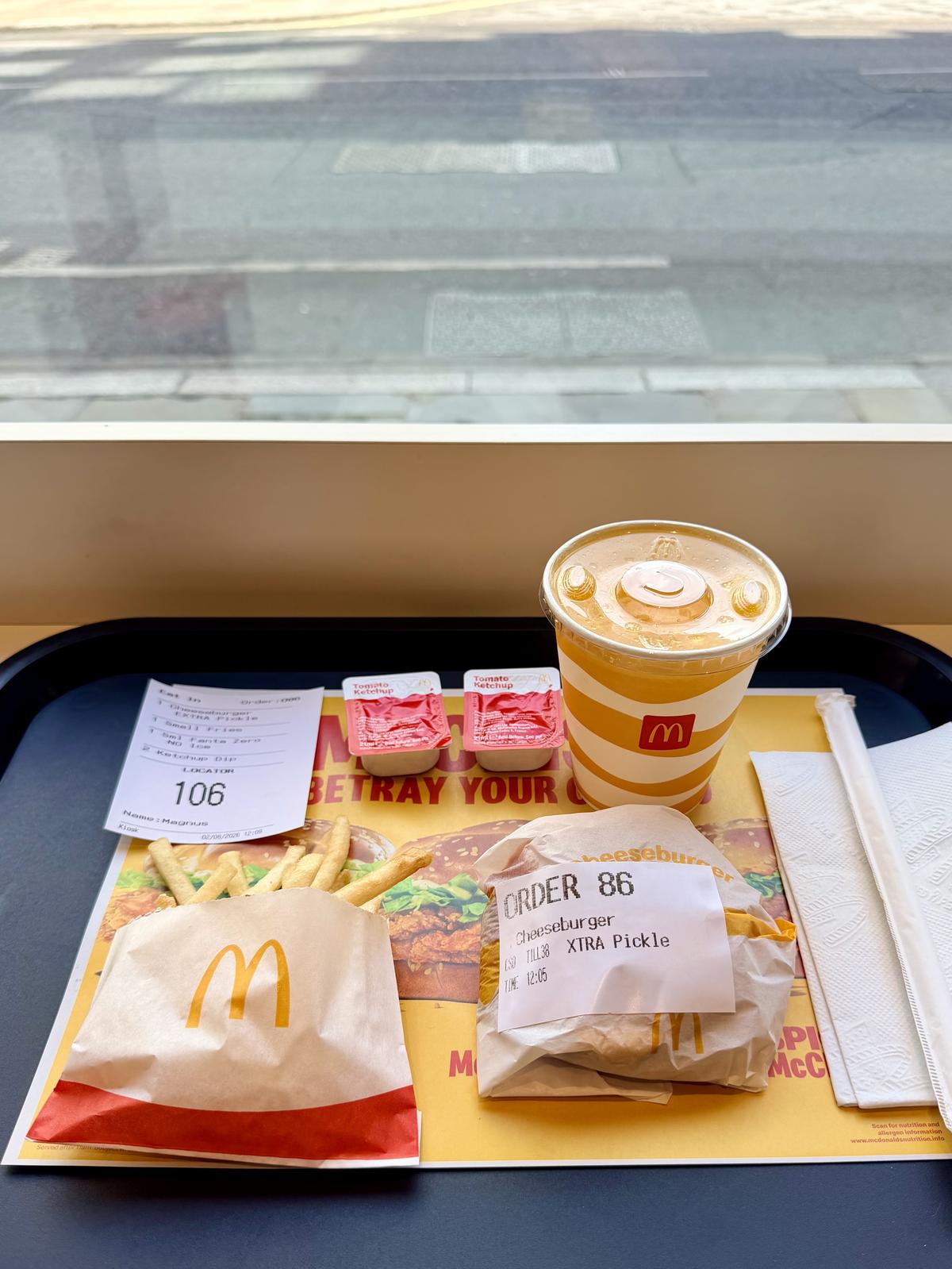 McDonald's tray with a cheeseburger, fries and Fanta