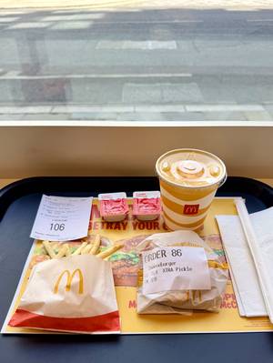 McDonald's tray with a cheeseburger, fries and Fanta